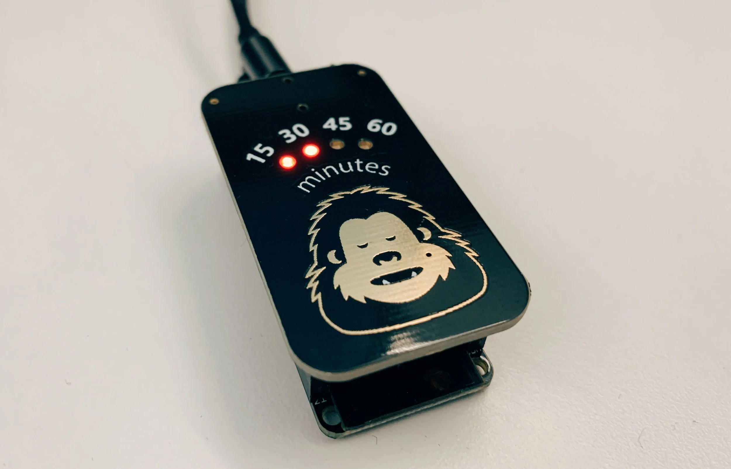 Close-up of a presence indicator PCB showing the yeti mascot design and red LEDs lit at the 15 and 30 minute positions. Image by Lee Murray.